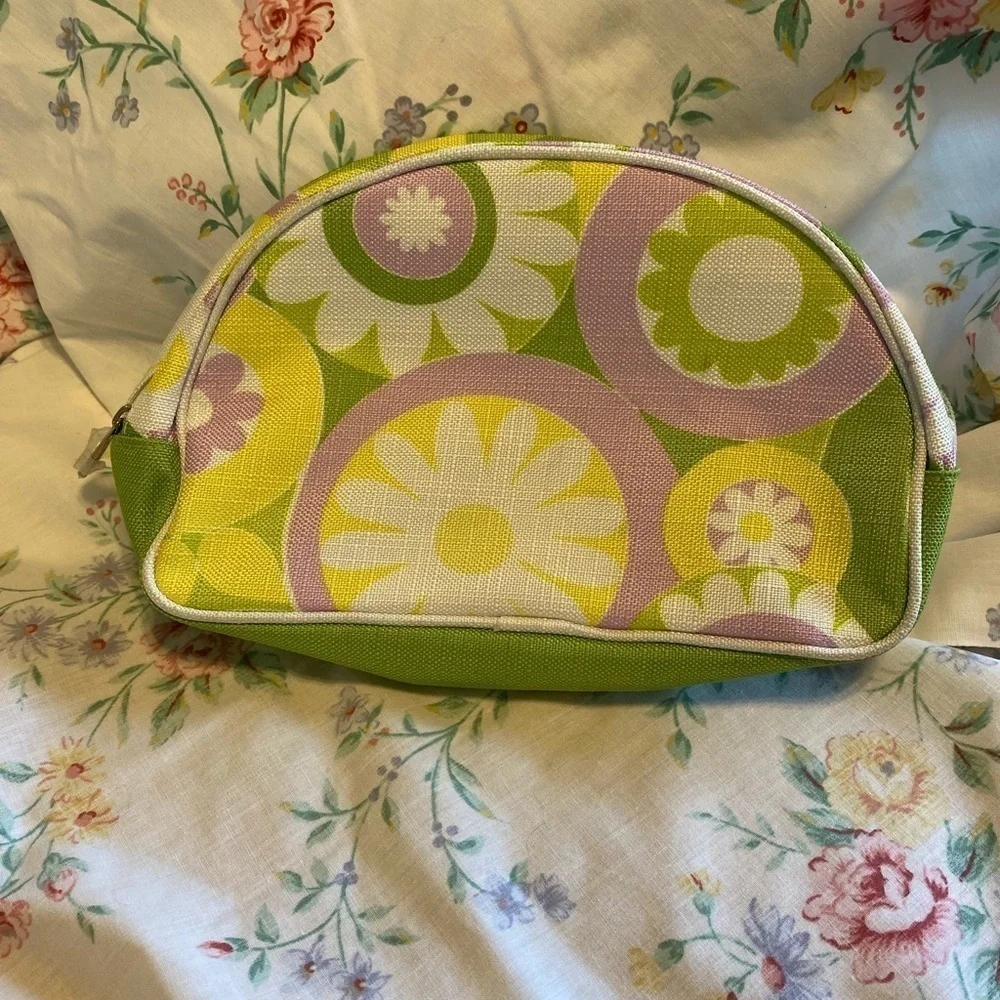 Clinique NWOT cosmetic bag. Green, yellow, purple and white. White inside
